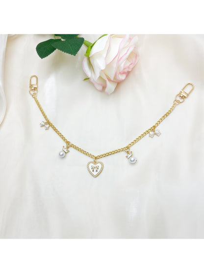 Heart bow pendant bag charm displayed on a white surface with soft shadows