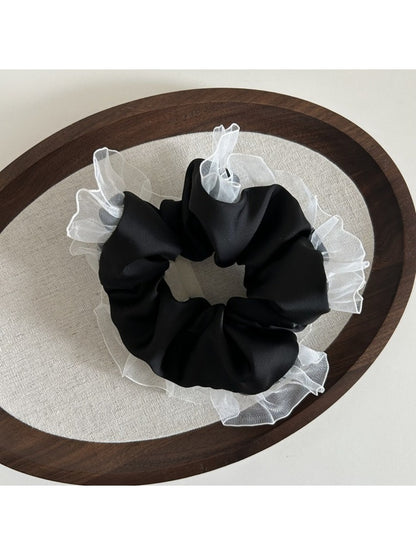 Top view of Gifty vintage tulle ruffle scrunchie highlighting texture and volume