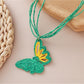 Detailed shot of raffia butterfly pendant highlighting natural fibers