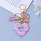 Heart cutout pendant keychain resting on a textured fabric surface