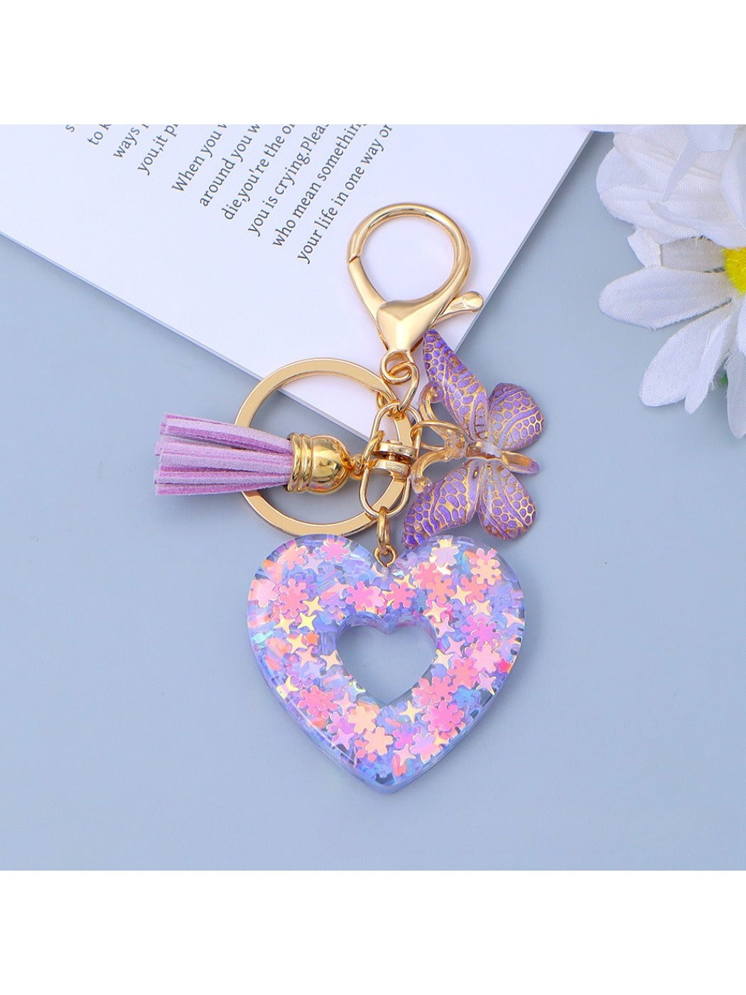 Heart cutout pendant keychain resting on a textured fabric surface