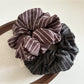Gifty scrunchie wrapped around a ponytail on a model