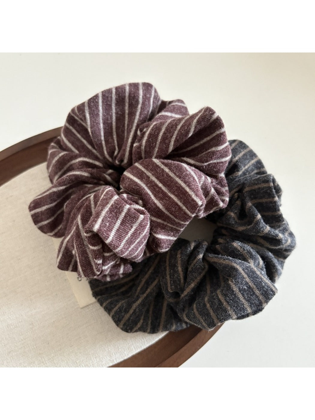 Gifty scrunchie wrapped around a ponytail on a model