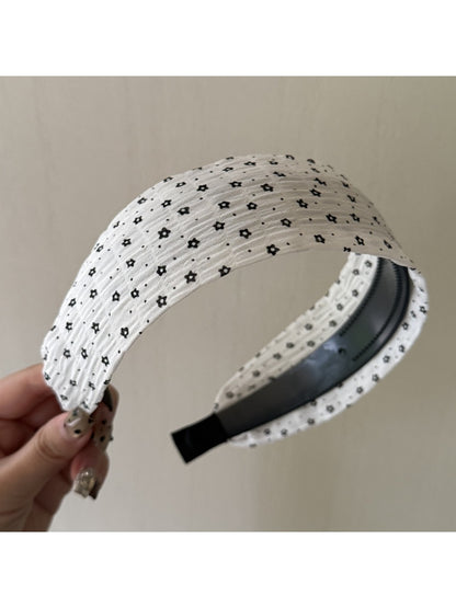 Side view of Gifty wide edge floral print headband on white background
