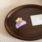 Top view of Beau acetate hair clip with colorful flowers on translucent base