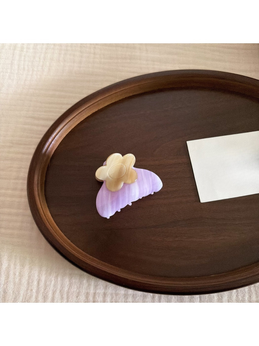 Top view of Beau acetate hair clip with colorful flowers on translucent base