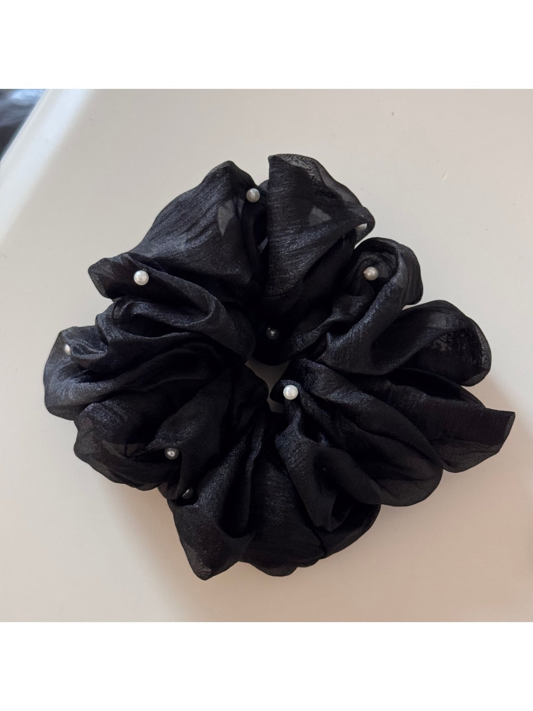 Gifty Comfy Foggy Simplicity scrunchie folded neatly on a textured cloth