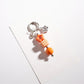 Colorful beaded star keychain displayed on a light fabric background