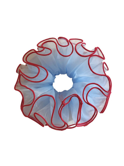 Side view of blue tulle scrunchie with red trim