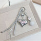Silver heart-shaped keychain with smooth polished surface on white background