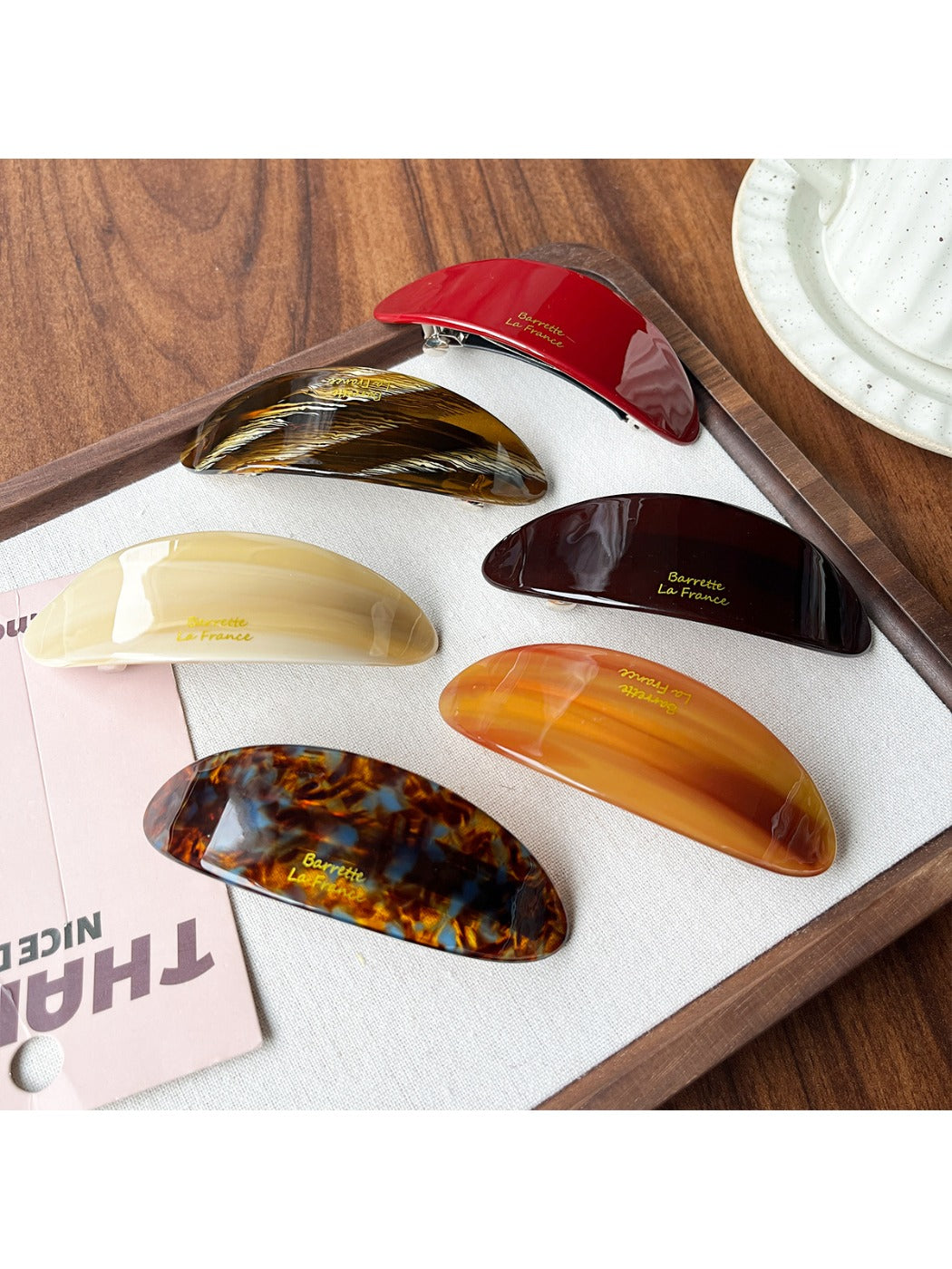 Close-up of Beau oval ponytail hair clip showing smooth acetate finish and clasp mechanism