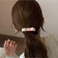 Model wearing the pink bow embellished hair tie in a ponytail hairstyle