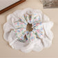 Gifty patchwork scrunchie laid flat showing mixed floral and plaid fabric sections
