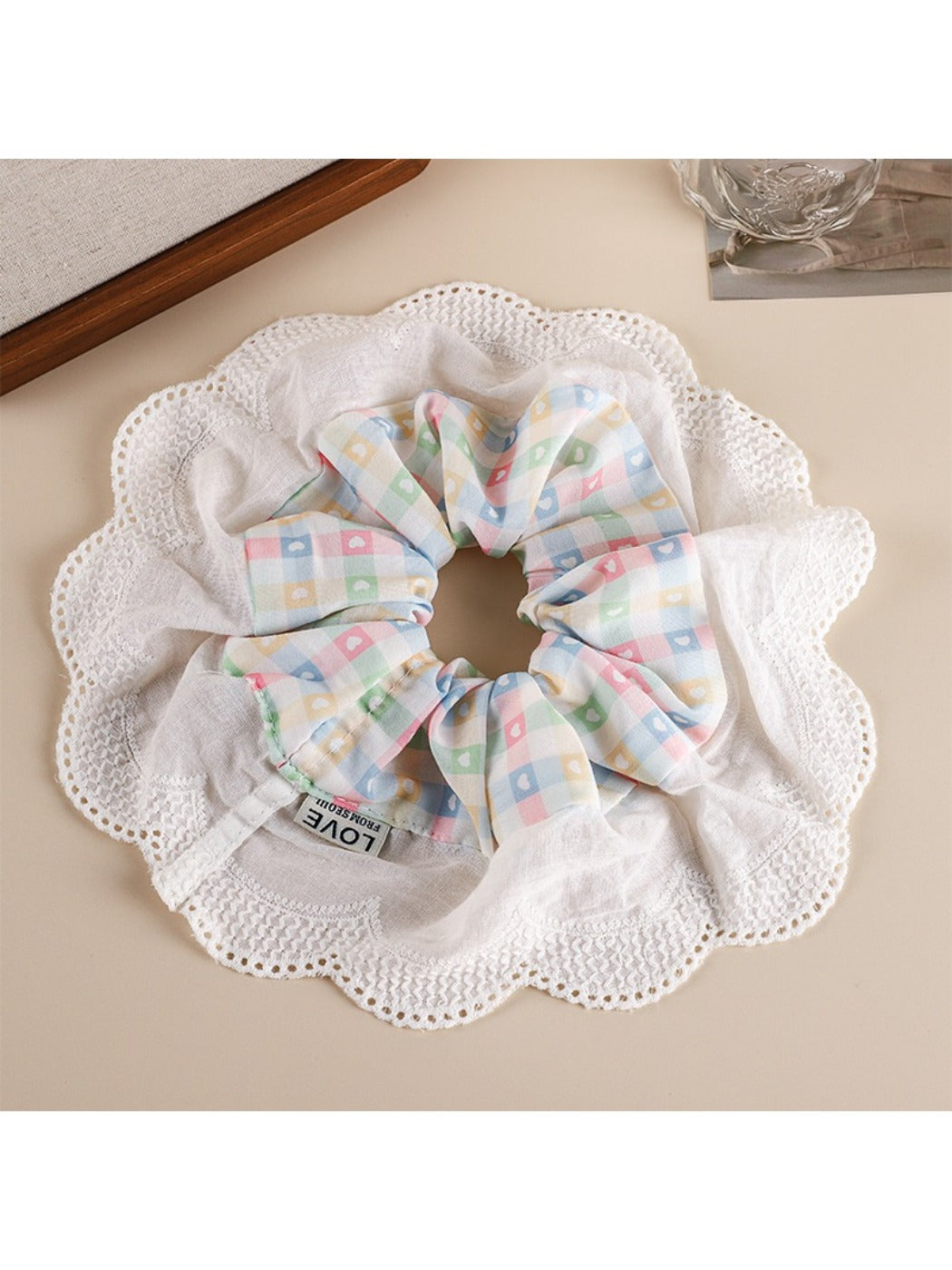 Gifty patchwork scrunchie laid flat showing mixed floral and plaid fabric sections