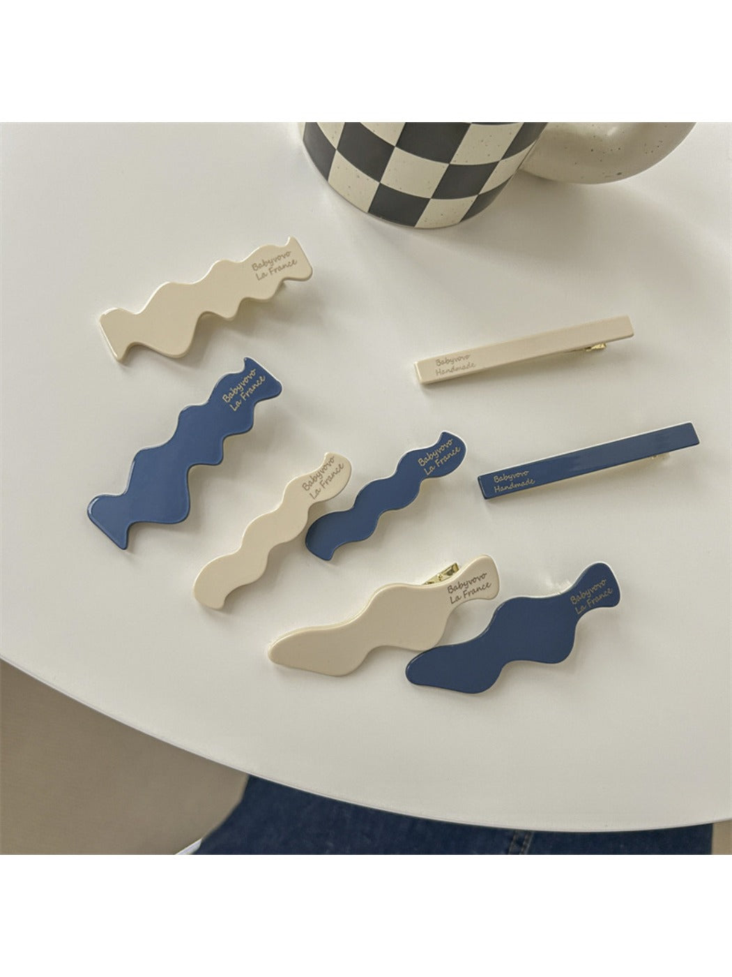 Blue and white Beau hair clip with a floral pattern on a white background