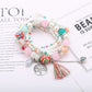 Lovra bracelet featuring tree-shaped tassel pendant and vibrant beads displayed on a hand