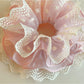Gifty sweet printed scrunchie styled in a ponytail with ruffled edges visible