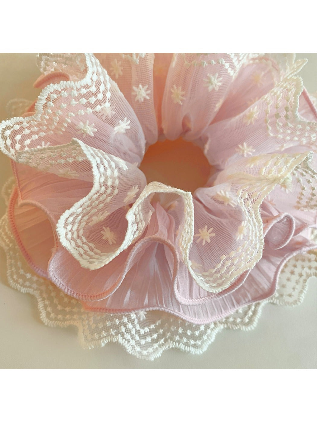 Gifty sweet printed scrunchie styled in a ponytail with ruffled edges visible