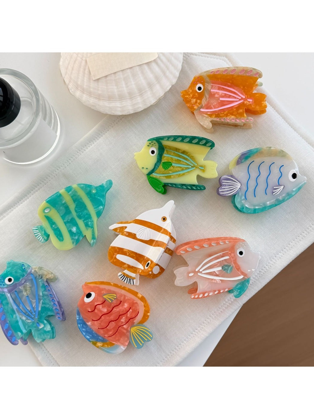 Close-up of Beau fish shaped claw clip showing vibrant blue and orange colors