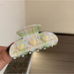 Beau Fresh Plaid Acetate Hair Clip held in hand to show size and scale