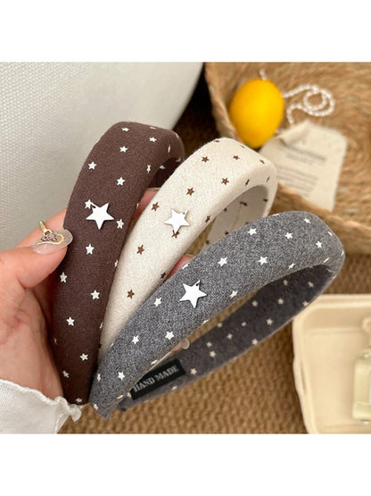 Side view of the solid color star hairband showing the star detail and band texture