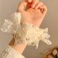 White lace bow scrunchie styled in a ponytail