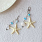 Side view of the keychain showing starfish and fish charms attached to the ring