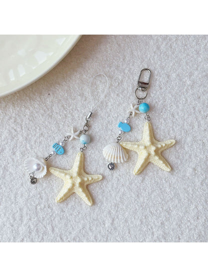 Side view of the keychain showing starfish and fish charms attached to the ring