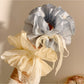 Side view of Gifty blue bow scrunchie highlighting the bow shape and elastic band