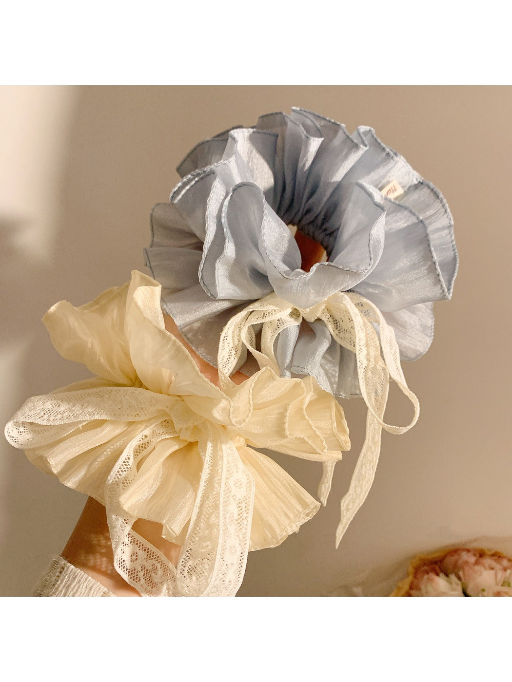 Side view of Gifty blue bow scrunchie highlighting the bow shape and elastic band