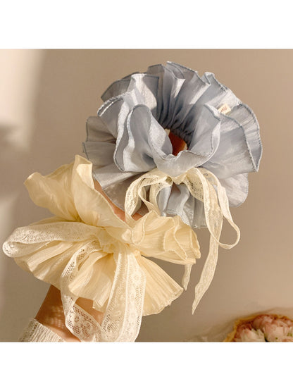 Side view of Gifty blue bow scrunchie highlighting the bow shape and elastic band