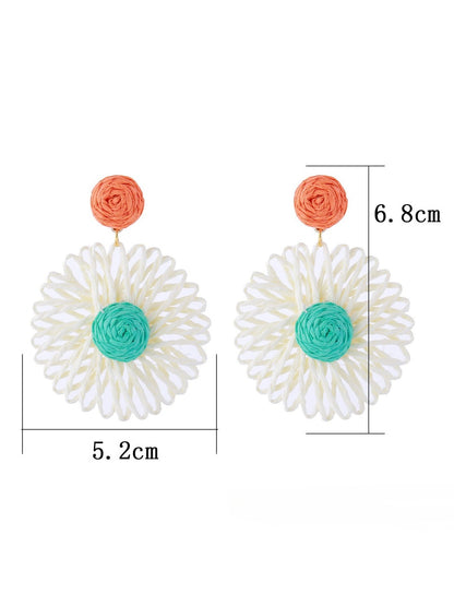 Side view of raffia sunflower earring showing woven texture and gold-tone stud