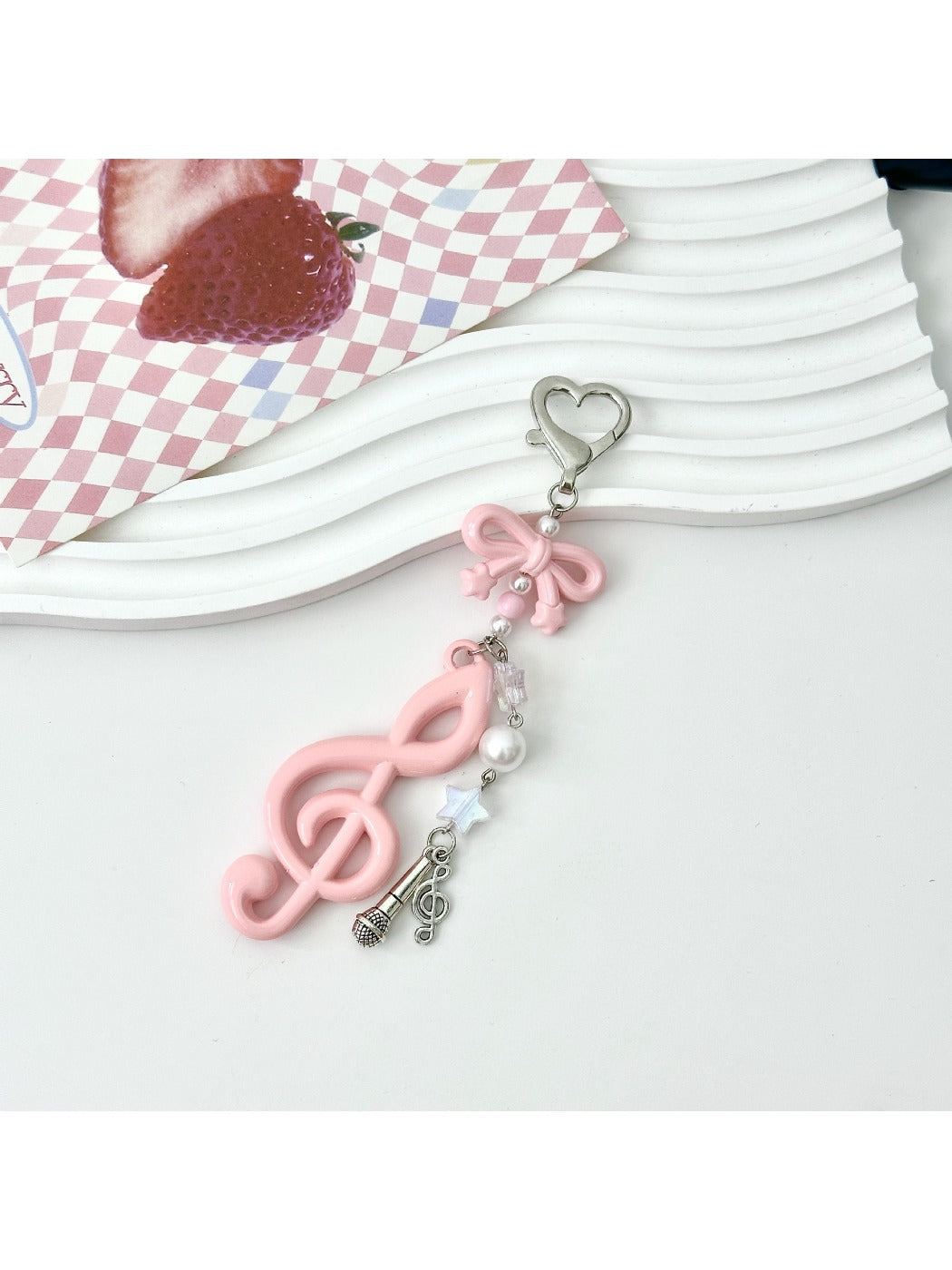 Keypus music note keychain attached to a set of keys on a wooden surface
