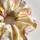 Set of oil painting style scrunchies in various bright colors displayed on white background