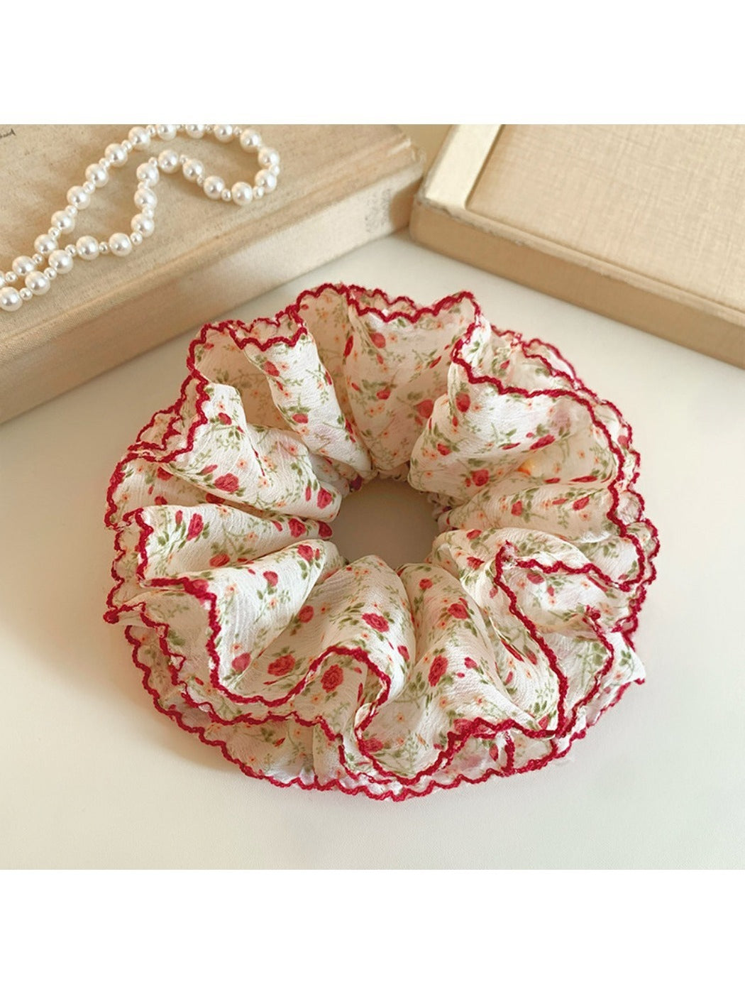 Red scrunchie with tiny white floral print on fabric