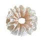 Gifty sweet light pink scrunchie folded neatly on a fabric surface