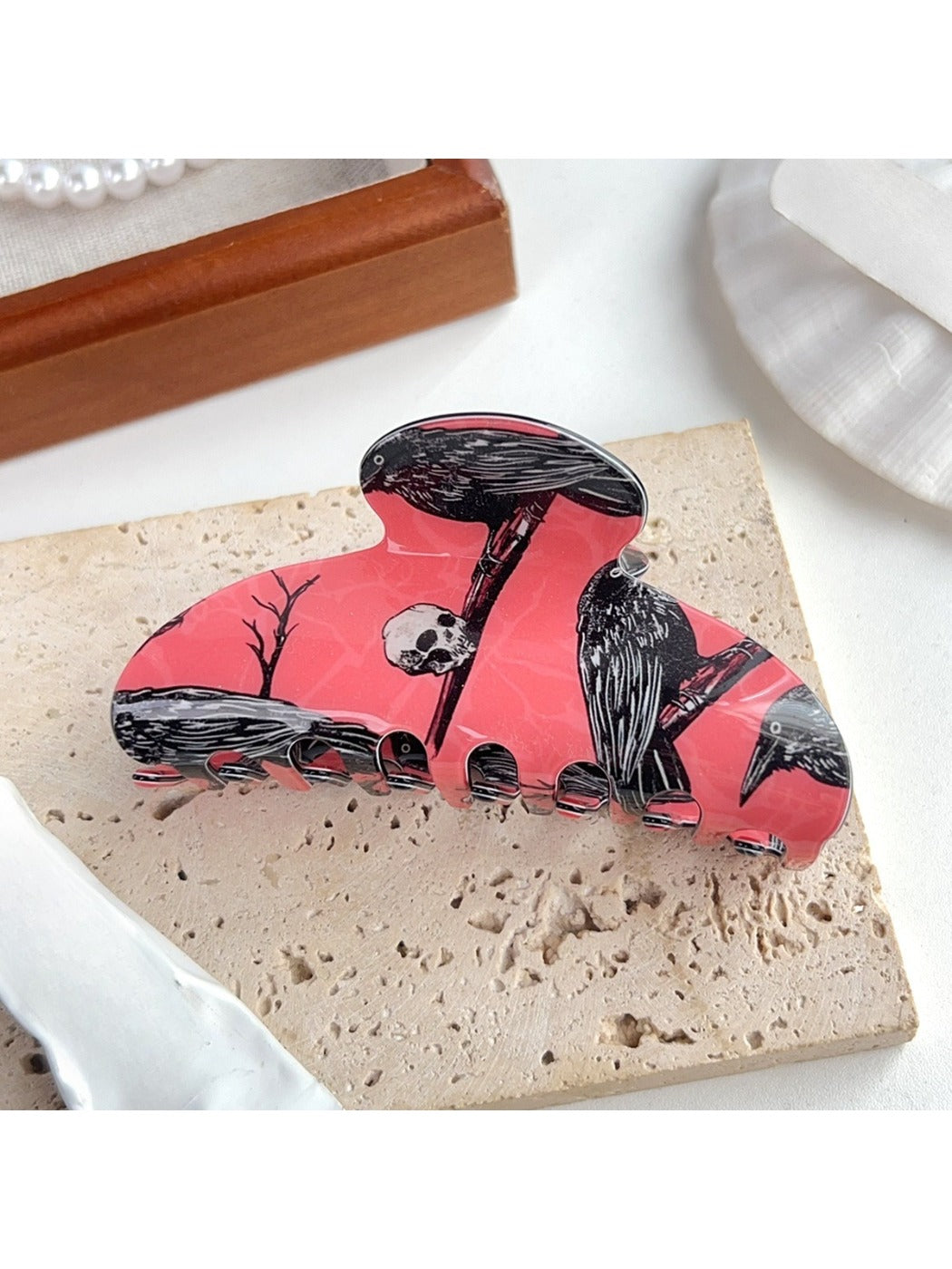 Beau hair claw clip open to show spring hinge and crow pattern details