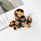 Beau vintage double flower hair claw clip placed on a white fabric background