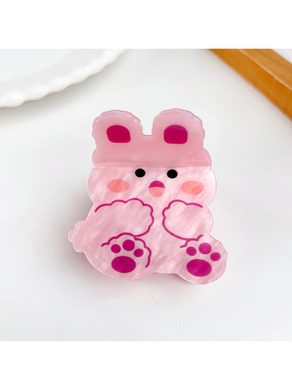Beau cute animal hair claw clip in beige displayed on a wooden surface