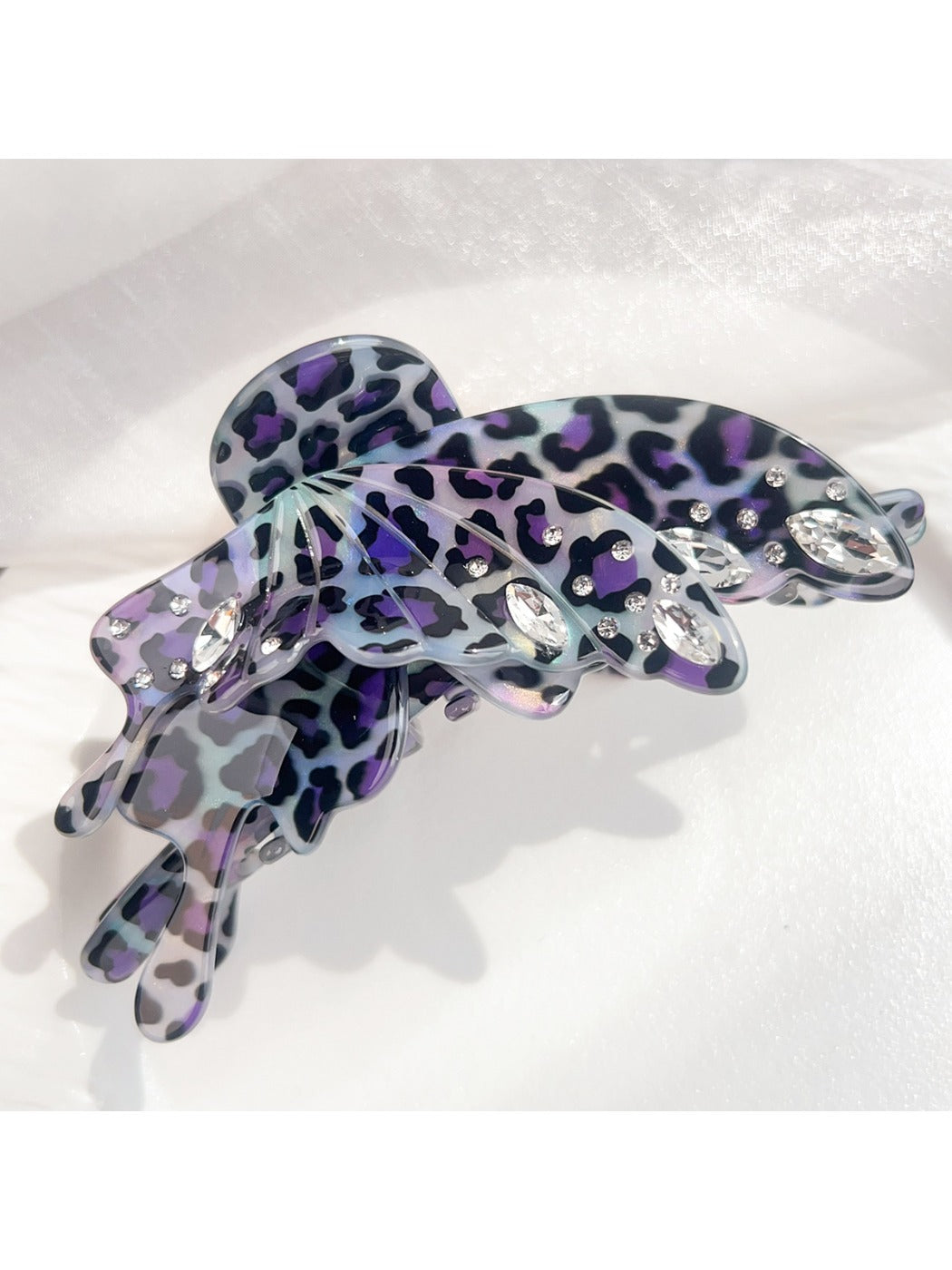 Beau butterfly claw clip with leopard print shown from angled side