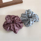 Side view of Gifty floral and polka dot scrunchie with gathered fabric