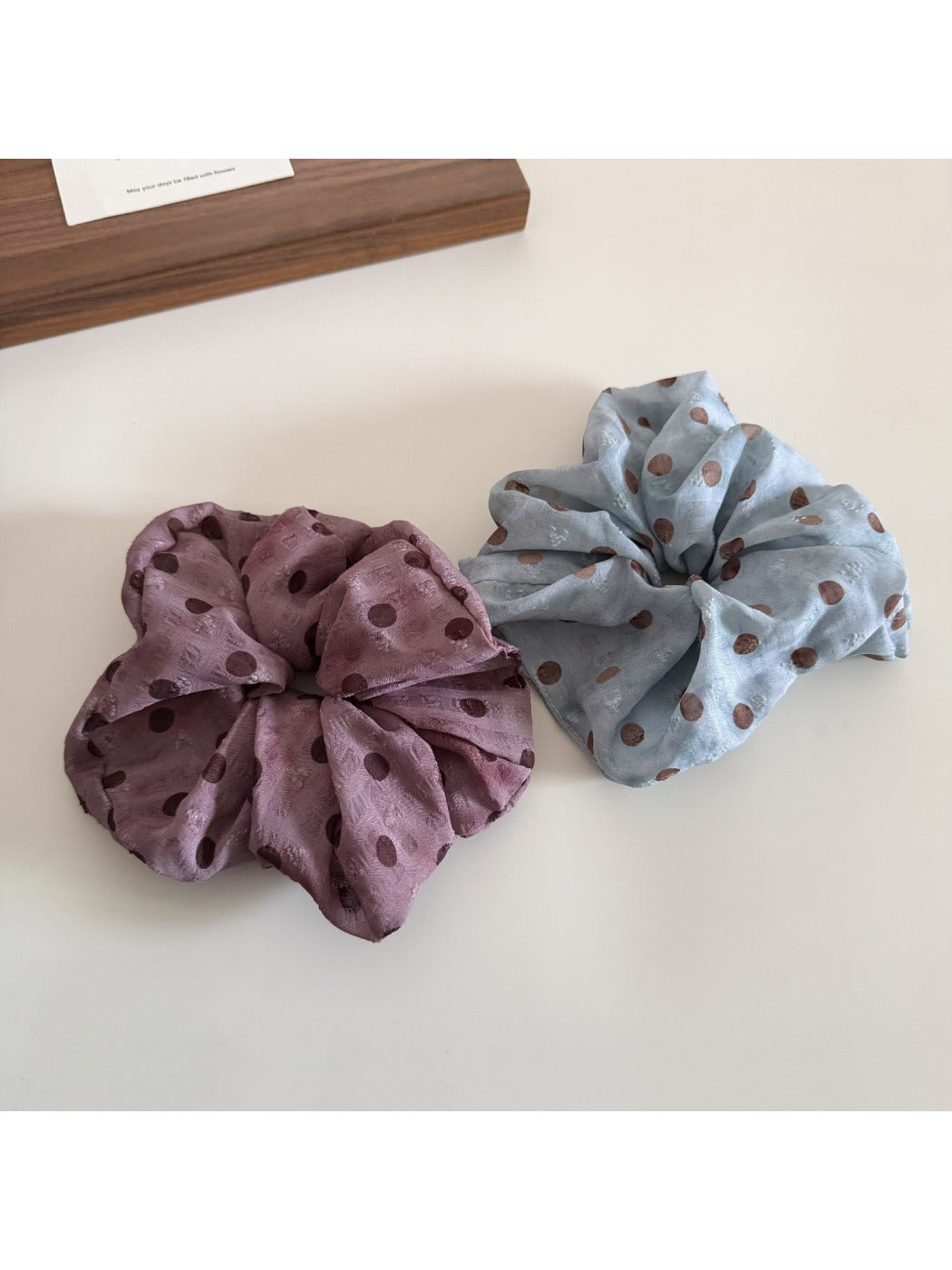 Side view of Gifty floral and polka dot scrunchie with gathered fabric