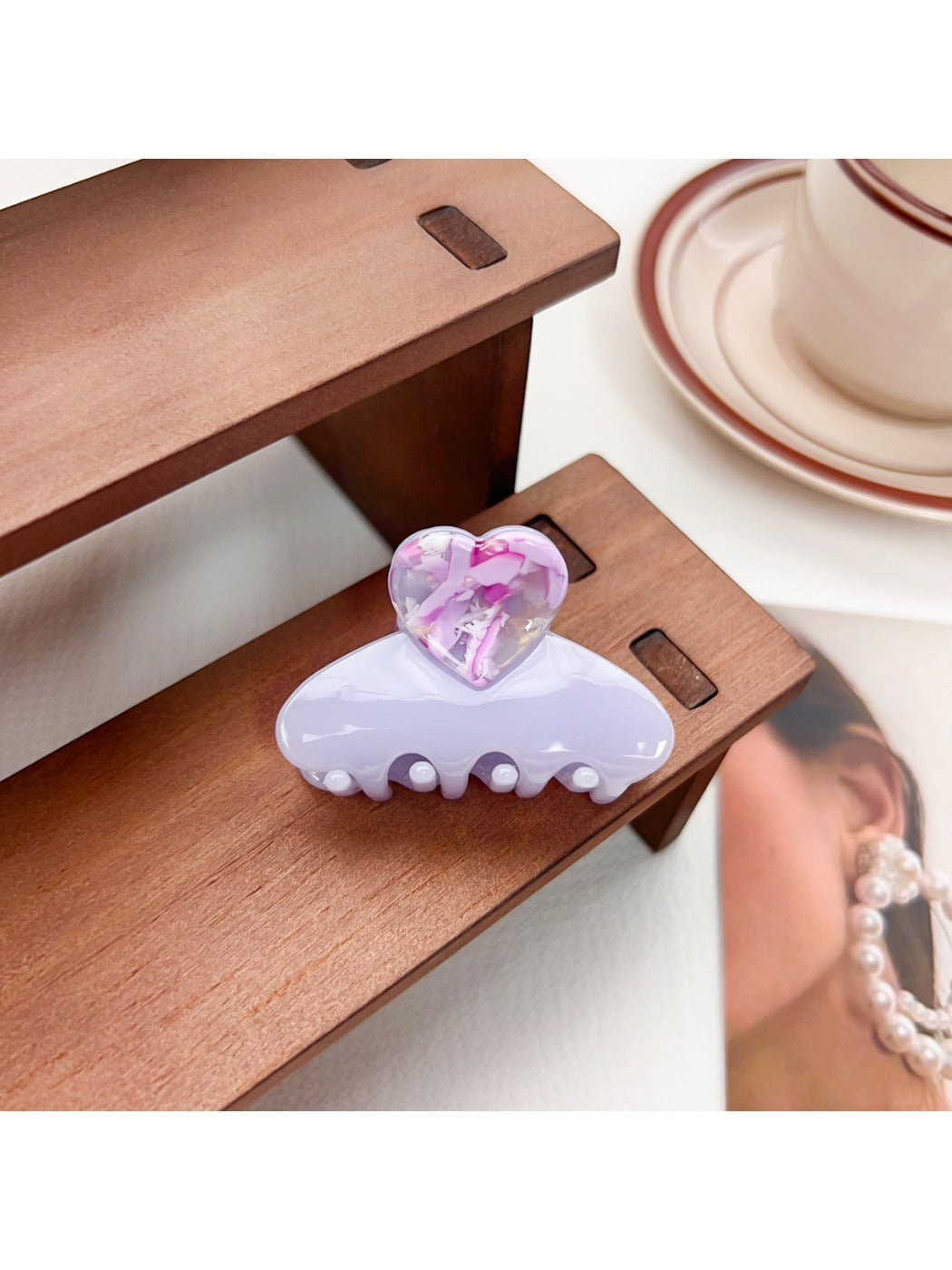 Beau medium heart shaped half circle claw clip next to matching hair accessories