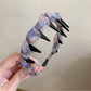 Top view of Gifty floral headband showing symmetrical flower print and smooth finish