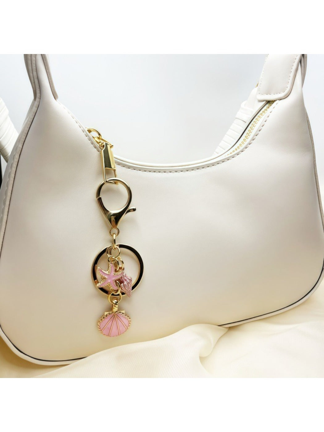 Side view of Keypus marine pendant keychain showing its polished metal finish