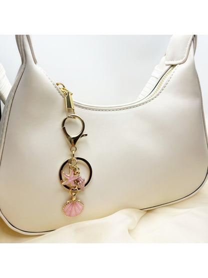 Side view of Keypus marine pendant keychain showing its polished metal finish