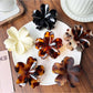 Beau leopard print flower shaped claw clip on white background