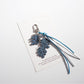 Keypus leaf shaped keychain displayed with matching leaf themed accessories