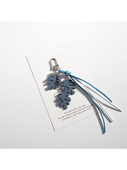 Keypus leaf shaped keychain displayed with matching leaf themed accessories