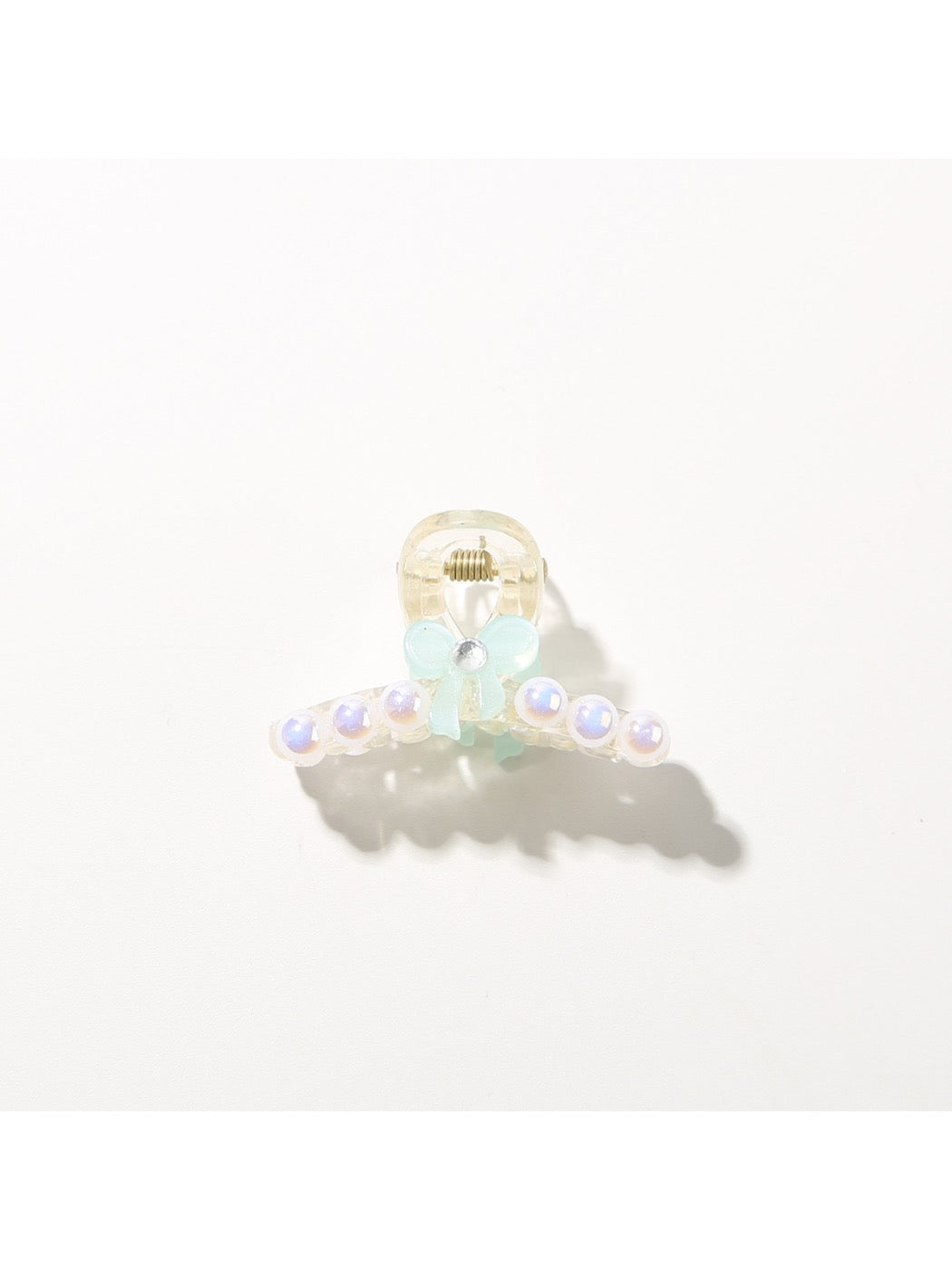 Bright multi color hair clip shown alongside matching accessories
